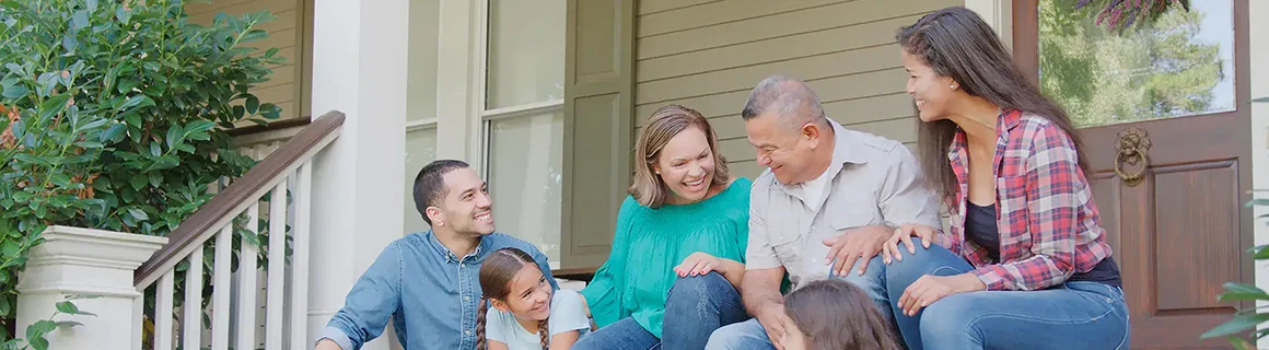 Family standing together on their front porch